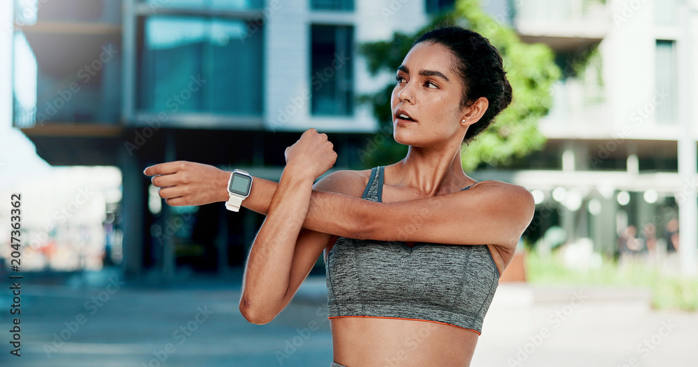 Naklejka premium Stretching, thinking and woman in city for fitness, health and mobility to prepare for exercise. Runner, sports and person with warm up for wellness, injury prevention and arm muscle for active hobby