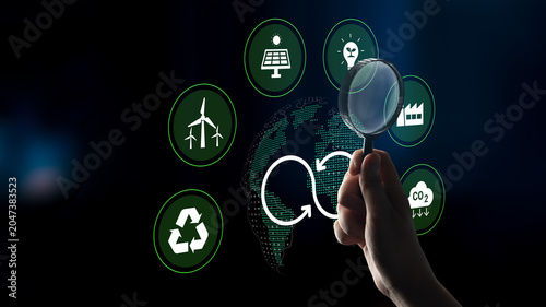 Принти на полотні A hand holds a magnifying glass over various renewable energy icons representing sustainability and eco-friendly innovations promoting a greener future