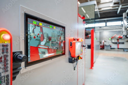 Control panel screen showing automated industrial robot in factory