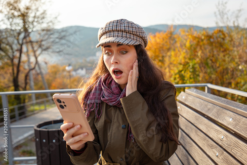 Photos Young woman expressing genuine shock after reading unexpected news online