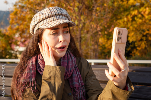 Photos Caucasian female looking stunned while reading an important message online