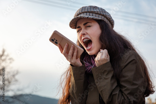 Foto Female participating in a heated remote conversation using mobile technology