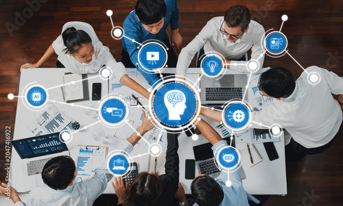 A dynamic team collaborates around technology, focusing on artificial intelligence and digital strategies, showcasing interaction and innovative solutions for future challenges. Amity