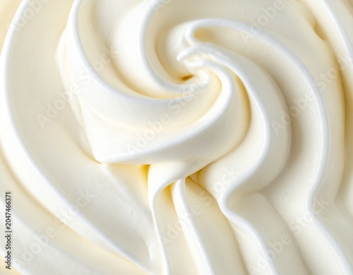 Close up of smooth vanilla ice cream background texture, creamy soft serve swirl frozen dessert