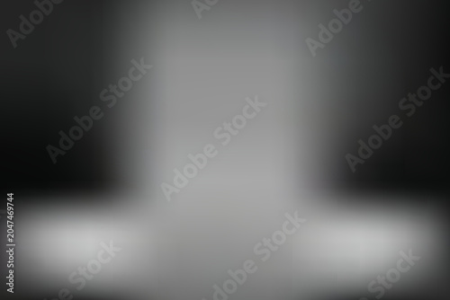 A gray blurry object sits on a surface against a dark transparent background