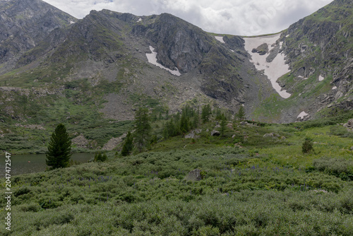 Photos Scenic view of Karakol Lakes alpine landscape with rocky peaks, lingering snowfi