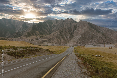Foto Empty asphalt road of the Chuysky Trakt stretching through rugged Altai Mountain