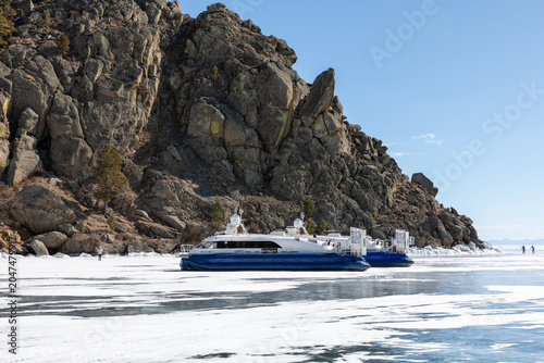 Foto Irkutsk Oblast, Russia - March 28, 2025: Two hovercraft travel across the frozen