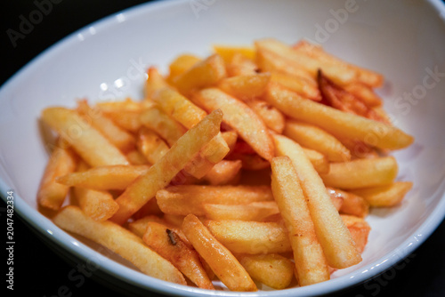 Fresh fried potatoes in white bowl 