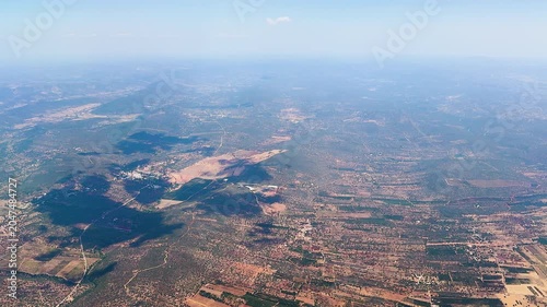 Elevated landscape shows winding roads weaving through rolling hills. High quality 4k footage