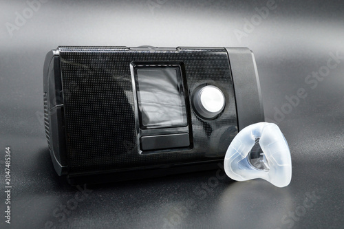 Continuous positive airway pressure or CPAP medical device with nasal mask for the treatment of sleep apnea, also called obstructive sleep apnea or sleep-related breathing disorder.