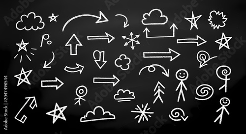 Doodle collection of chalk arrows stars and clouds on black chalkboard