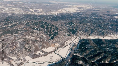 view of mountains ,villages and agricultural fields in winter season,taken from plane window
