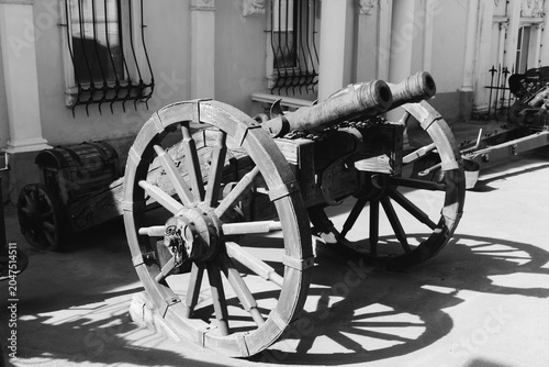 Canvas Print Satka, Russia - May 9, 2025: Black and white photo of an old wooden cannon on a