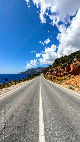 A scenic road winding through a rugged landscape