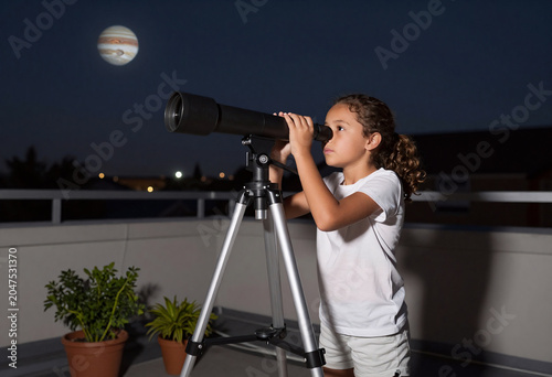 Girl Exploring Jupiter with Telescope on Rooftop