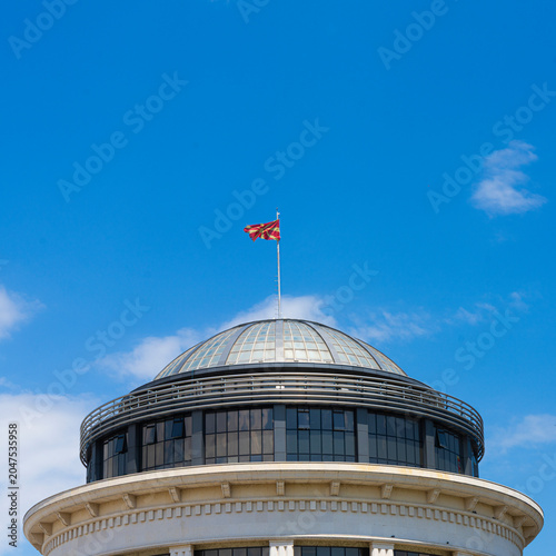 Fotografie Macedonian flag flies atop a dome of a building