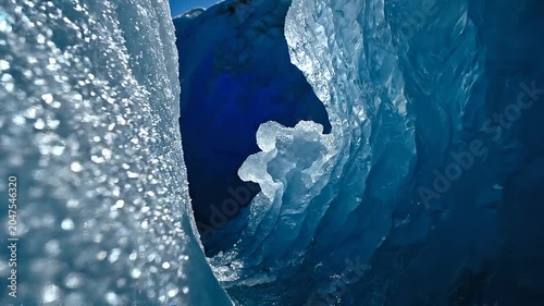 Macro view of shimmering blue ice inside a glacier crevice