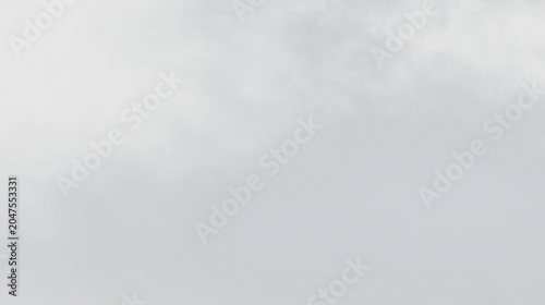 Bild auf Leinwand Clouds gather in the sky over a quiet landscape, signaling a change in weather d