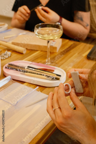 Silver clay ring shaping at workshop with champagne coupe glass, bridal activities, jewelry class