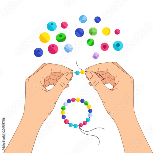 Obraz na plátně A pair of hands stringing colorful beads to create a handmade bracelet