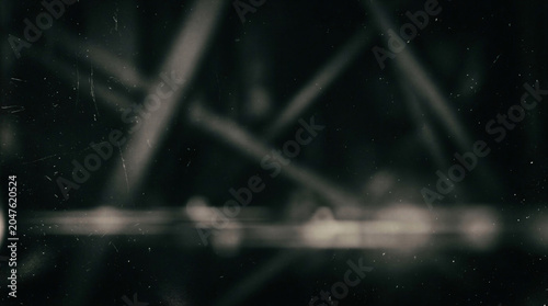 Dark abstract grunge texture background with heavy scratches and dust particles.
