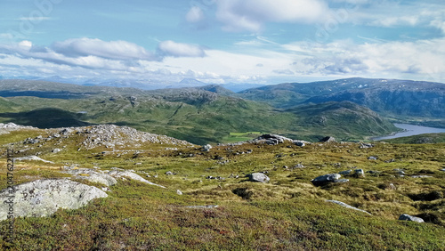 Panoramic view of Arctic tundra landscape and fjords from Nattmalsfjellet mountain in Kvaloya Island, Tromso, Northern Norway. Hiking trail view over majestic hills near Tromso region.