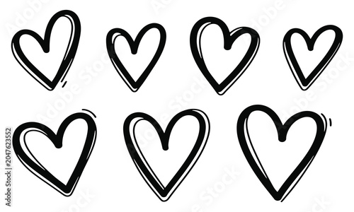 Set of hand-drawn black heart icons with brush stroke outlines isolated on a white background.