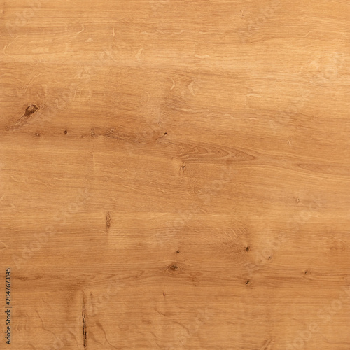 Natural oak tabletop background with warm brown tones, subtle grain and knots...