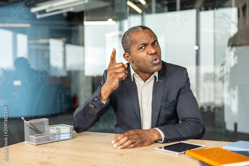 Photography Adult male executive expressing strong disapproval in a corporate setting, showi