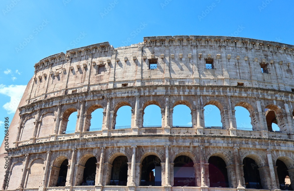 Fototapeta premium Colosseum Historic Landmark Under Blue Sky in Rome Italy
