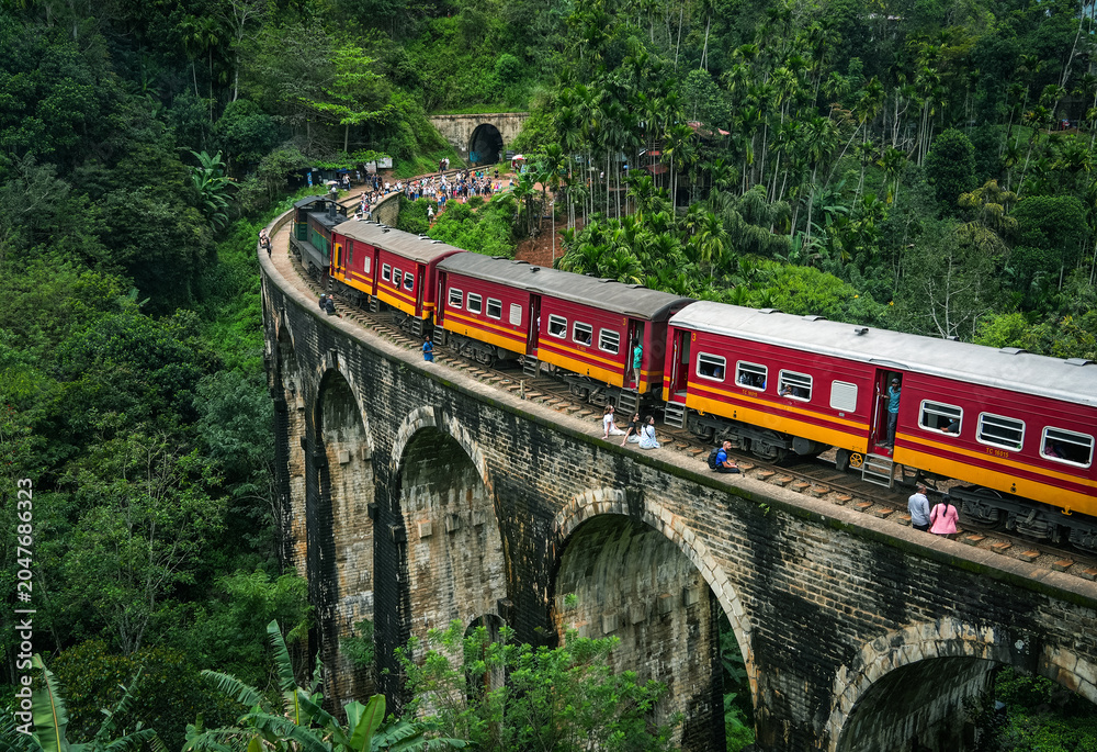Naklejka premium Image of the train running along the Nine Arches Bridge located in valley Demodara, Ella, Sri Lanka, Asia