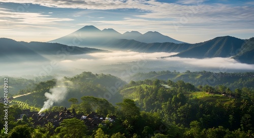 Scenic morning view of misty green valley and distant mountains under a cloudy sky in Bali, Indonesia