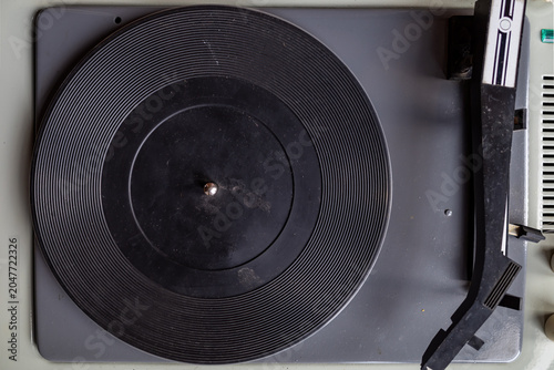 Close-up of a vintage record player turntable and tonearm.