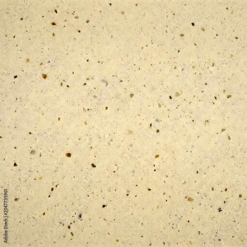 Close-up of beige terrazzo texture, speckled stone surface, flecked pattern, decorative flooring material