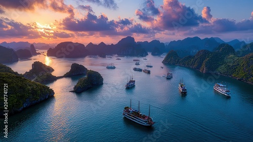 Sunset over Halong Bay with cruise boats and islands