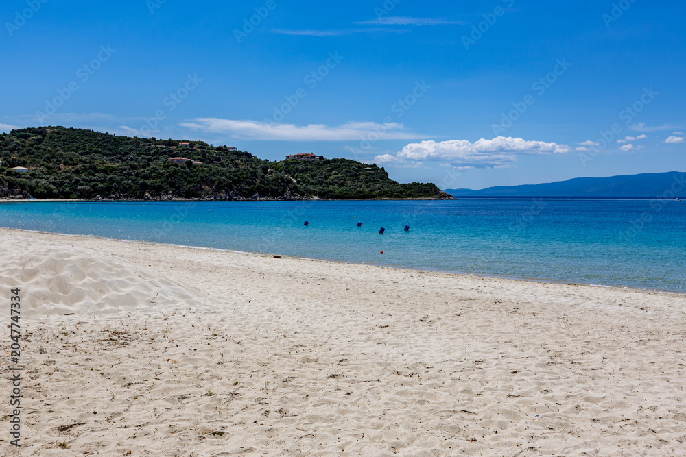 Fototapeta premium There are people on the beach in the water and in the sand, Ammoulliani, Greece