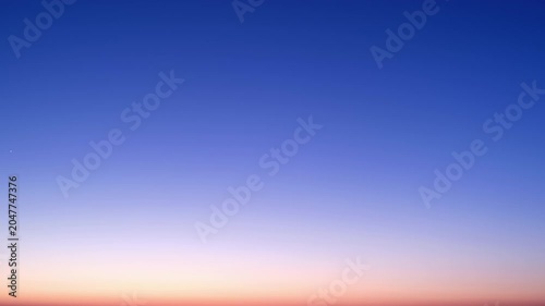 Night sky gradient transition from dark blue to twilight horizon, time lapse. Atmospheric background featuring star light and dusk glow. Evening sky stage for cosmic texture and celestial design.