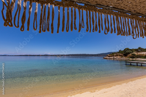 View of a beach with a dock and a body of water, Ammoulliani, Greece