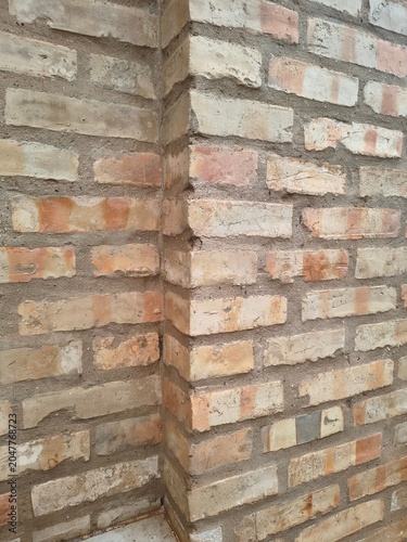 Brick wall corner showing rustic texture and weathered brick masonry pattern