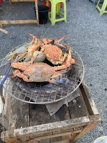 Mookata. Thai barbecue. Thai BBQ. Grilled pork. Thai food. Asian food. Barbecue grill. Hot pot. Dining together. Shared meal. Family dinner. Friends gathering. Restaurant dining. seafood.