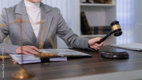 professional lawyer woman holding wooden gavel at desk in modern law office working on legal documents and court case justice legal system concept