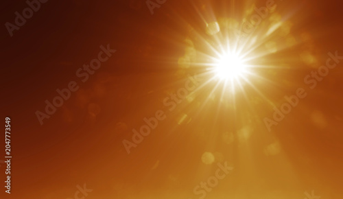 abstract photo of light burst among trees and glitter bokeh. image is blurred. yellow golden bokeh pattern background. Real optical lens flare on black backdrop. sunrays, sun rays beam, burst, sunbeam