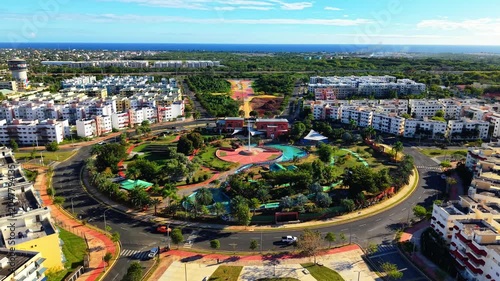 Aerial View of Modern Residential Community with Central Park and Ocean Horizon.