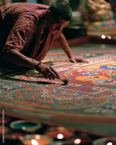Asian Monk Creating Vibrant Spiritual Mandala Painting - Traditional Art & Craftsmanship in Sacred Rituals