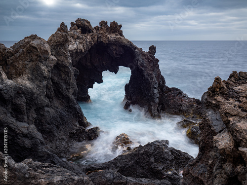 rocky sea arch at sunrise