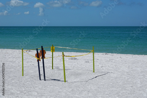 Schilderij op canvas A designated turtle nesting area bordered by yellow stakes and caution tape