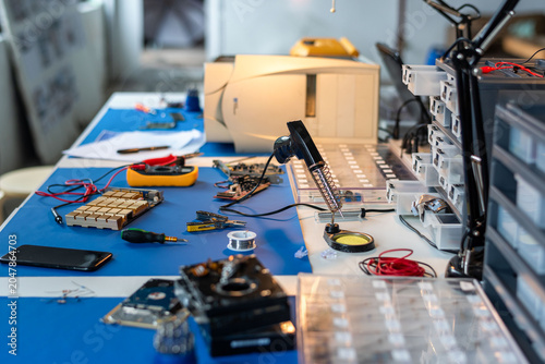 Electronics repair bench with tools  circuit boards  and test equipment