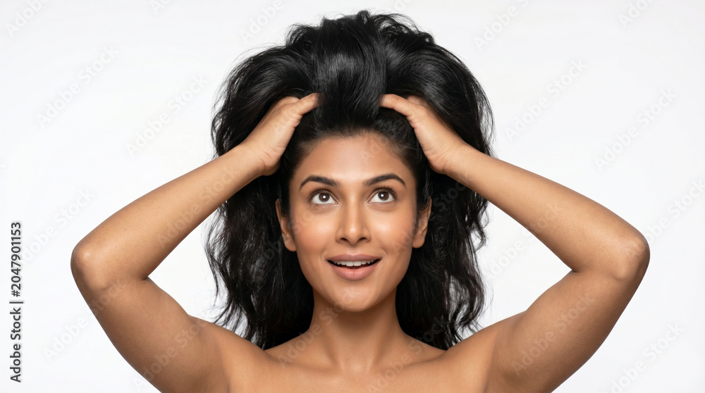 Fototapeta premium Smiling woman touching her hair with joy