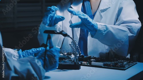 Professional technician soldering PCB circuit board with precision tools in electronics lab, showcasing hardware engineering, manufacturing, repair
